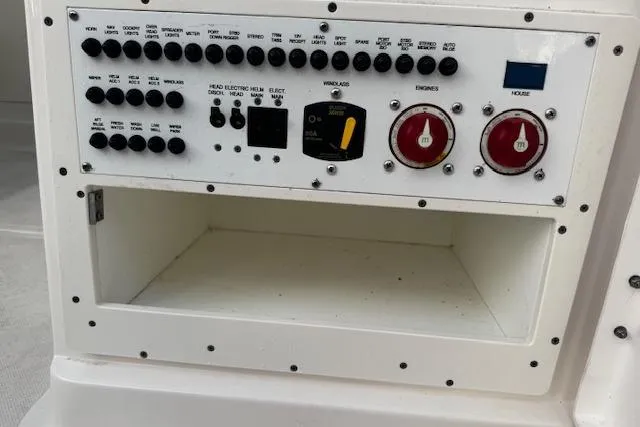 Slide: The Image of Control panel of a 2018 Pursuit DC 265 Dual Console boat, featuring switches and dials. - 27