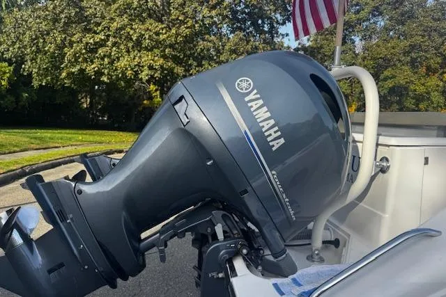 Slide: The Image of 2018 Pursuit DC 265 Dual Console with Yamaha outboard motor, American flag in background. - 29