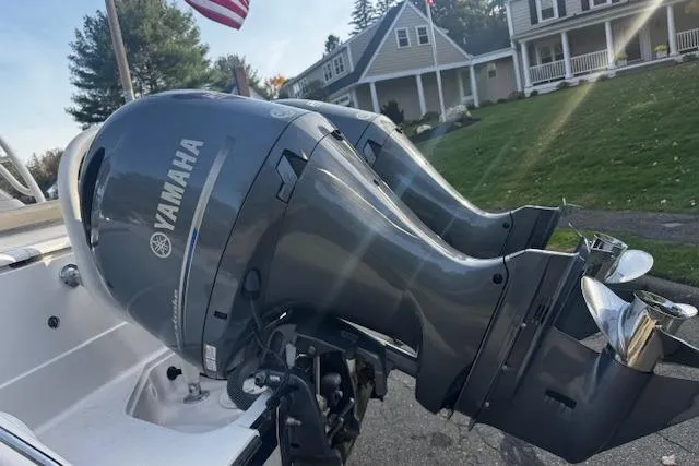 Slide: The Image of 2018 Pursuit DC 265 Dual Console with Yamaha outboard motors, parked in a residential area. - 30