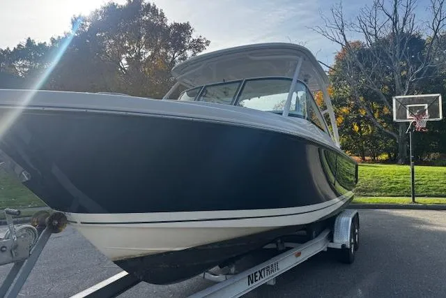 Slide: The Image of 2018 Pursuit DC 265 Dual Console boat on trailer, parked outdoors. - 32