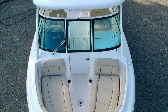 Slide: The Image of 2018 Pursuit DC 265 Dual Console boat with spacious seating and sleek design. - 8