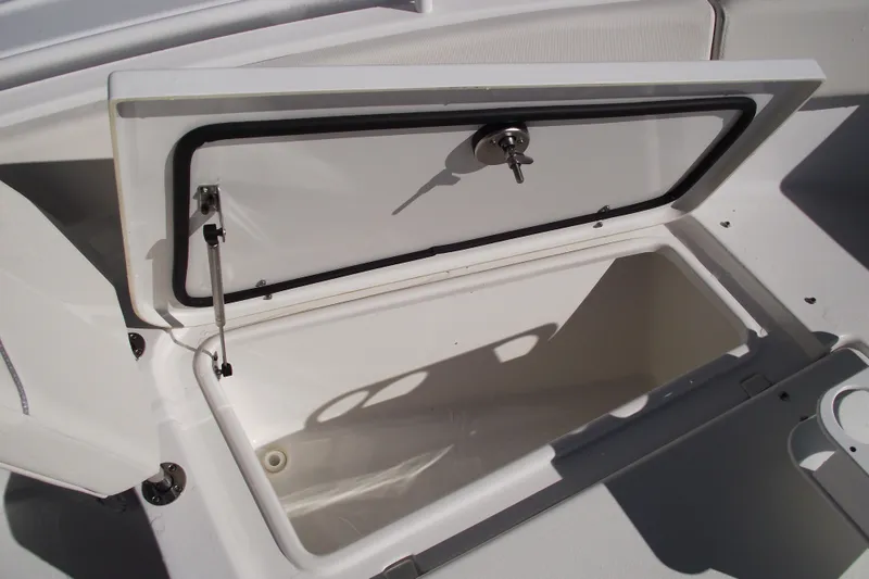 Slide: The Image of Open storage compartment on 2023 Sea Hunt Ultra 255 SE boat. - 10