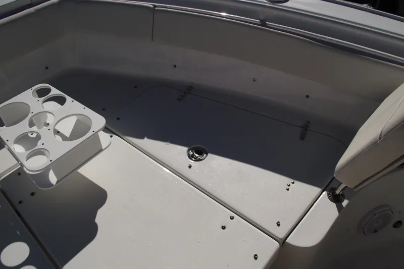 Slide: The Image of 2023 Sea Hunt Ultra 255 SE boat interior with cup holders and seating. - 11