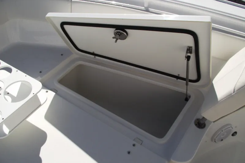Slide: The Image of Open storage compartment on 2023 Sea Hunt Ultra 255 SE boat. - 12