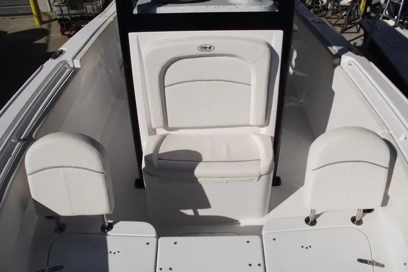 Slide: The Image of 2023 Sea Hunt Ultra 255 SE boat interior with white seating and sleek design. - 13