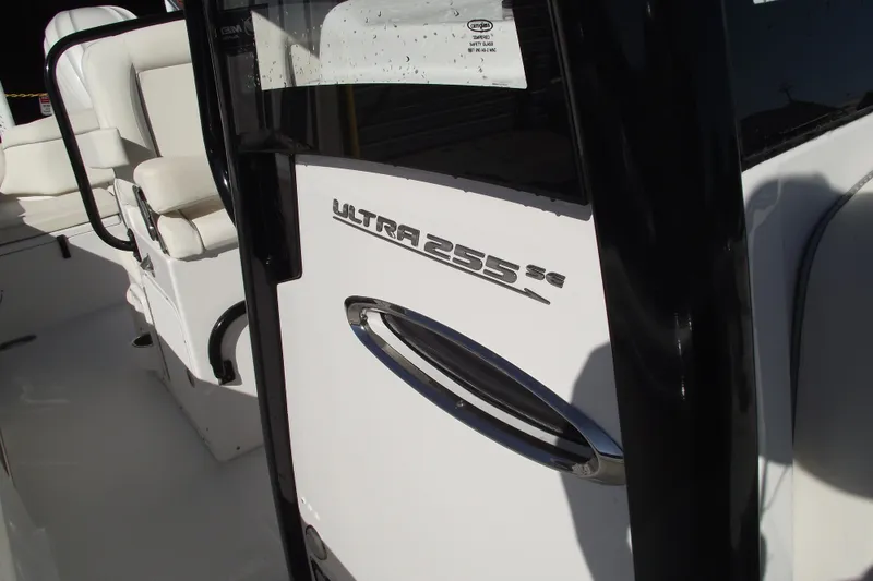 Slide: The Image of 2023 Sea Hunt Ultra 255 SE boat interior with seating and model branding. - 16