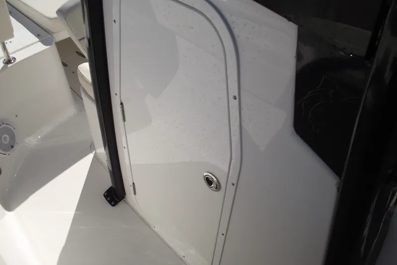 Slide: The Image of 2023 Sea Hunt Ultra 255 SE boat interior with sleek white cabin door. - 17