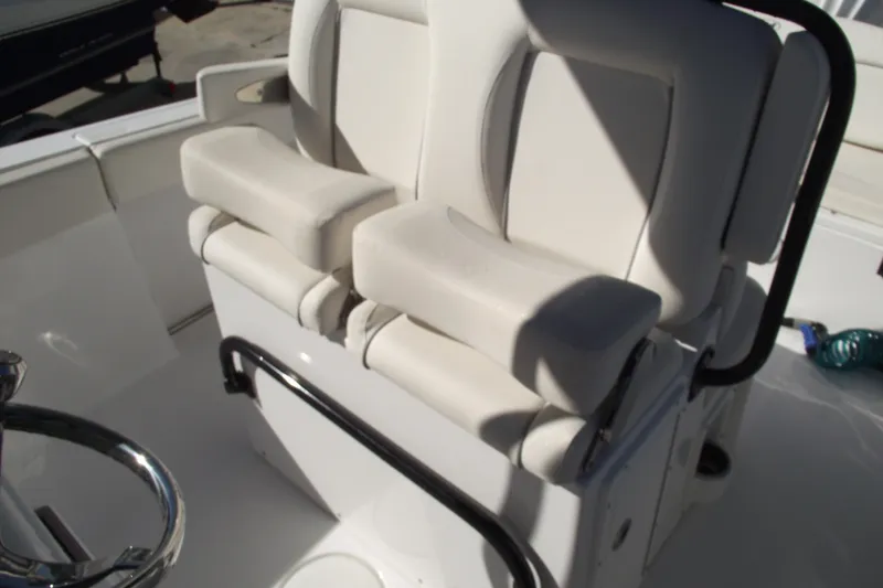 Slide: The Image of 2023 Sea Hunt Ultra 255 SE boat seating with cushioned armrests and sleek design. - 21