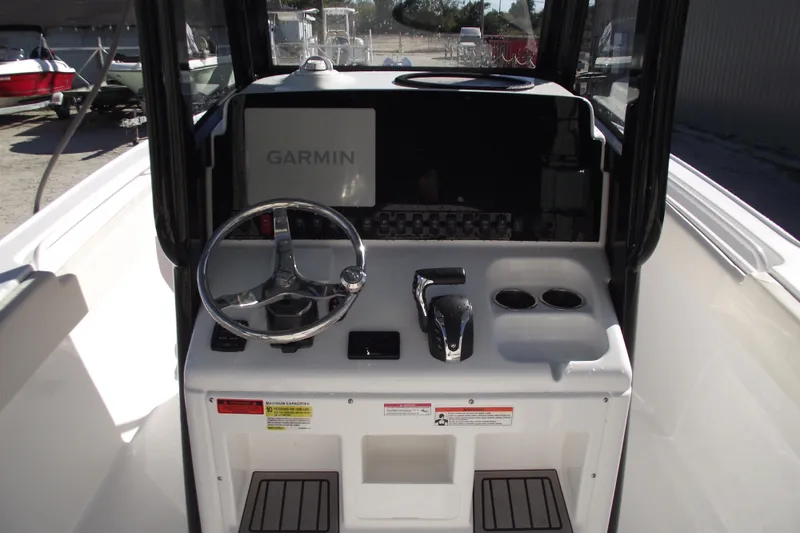 Slide: The Image of 2023 Sea Hunt Ultra 255 SE boat dashboard with Garmin navigation system and steering wheel. - 22