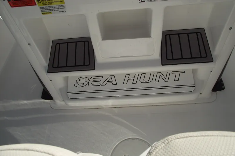 Slide: The Image of 2023 Sea Hunt Ultra 255 SE boat interior with logo and storage compartments. - 24