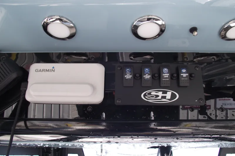 Slide: The Image of Control panel of 2023 Sea Hunt Ultra 255 SE with Garmin device and switches. - 25