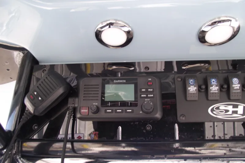 Slide: The Image of Control panel of 2023 Sea Hunt Ultra 255 SE with Garmin device and switches. - 26