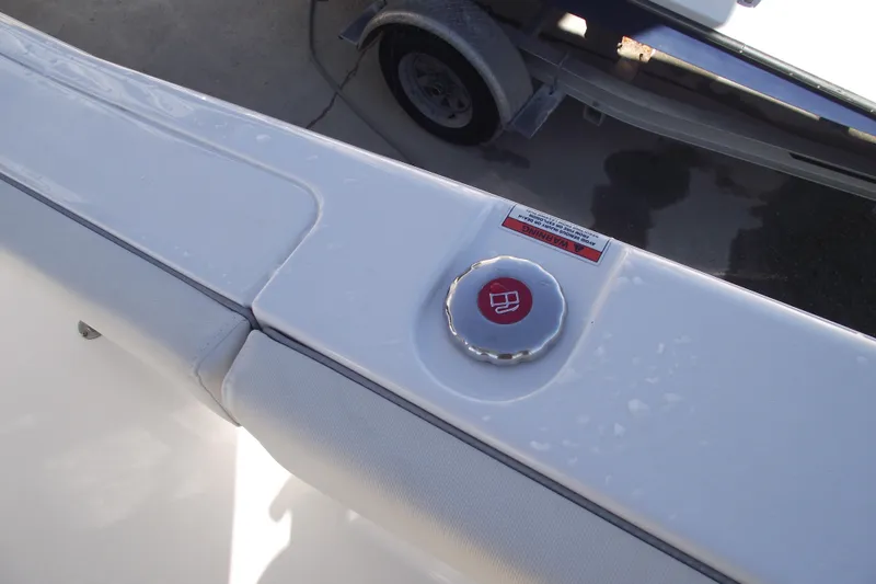 Slide: The Image of Fuel cap on 2023 Sea Hunt Ultra 255 SE boat, with warning label visible. - 28