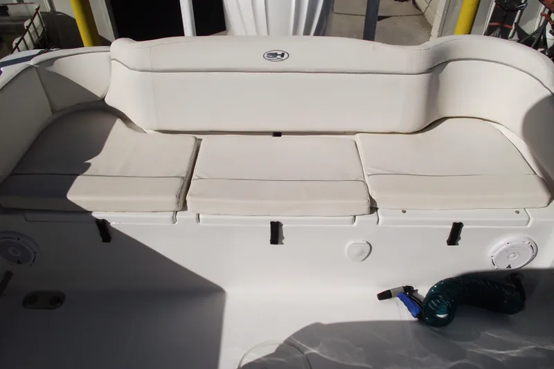 Slide: The Image of 2023 Sea Hunt Ultra 255 SE boat with cushioned seating and storage compartments. - 31