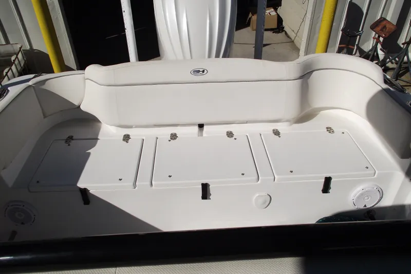 Slide: The Image of 2023 Sea Hunt Ultra 255 SE boat interior with white seating and storage compartments. - 32