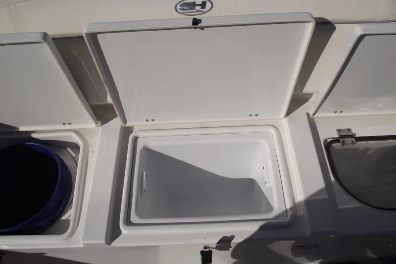 Slide: The Image of 2023 Sea Hunt Ultra 255 SE boat storage compartments open on deck. - 34