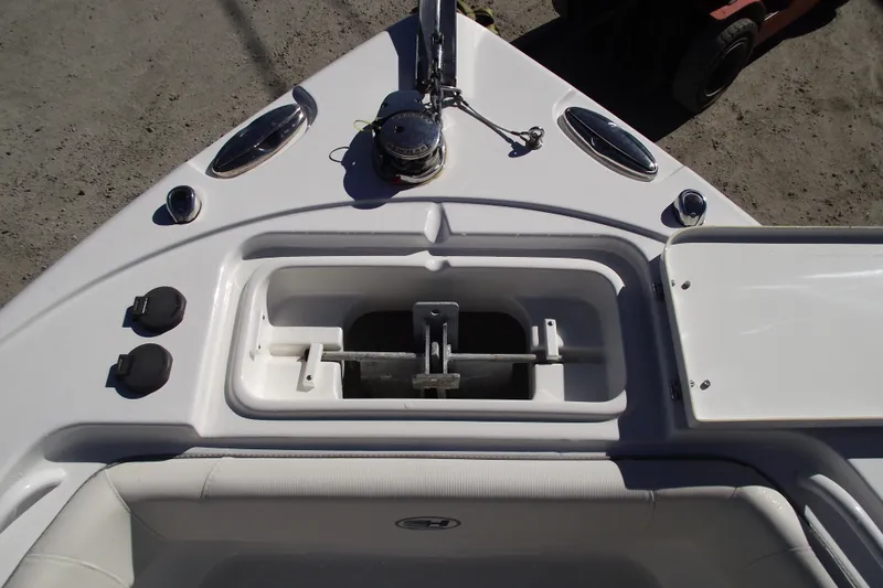 Slide: The Image of 2023 Sea Hunt Ultra 255 SE boat anchor compartment and deck features. - 7