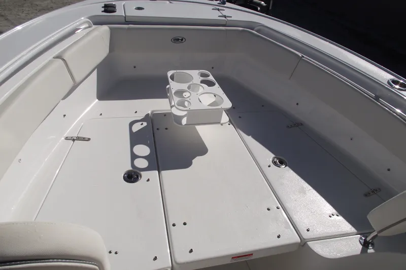 Slide: The Image of 2023 Sea Hunt Ultra 255 SE boat interior with seating and cup holders. - 8