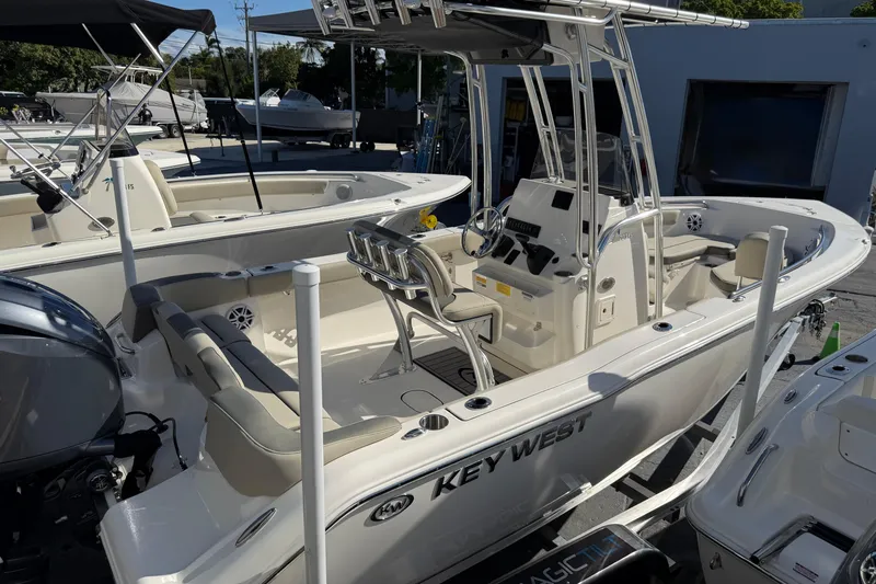 Slide: The Image of 2026 Key West 203 FS boat with center console and seating, displayed outdoors. - 11