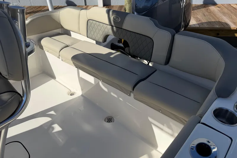 Slide: The Image of 2026 Key West 203 FS boat interior with cushioned seating and cup holders. - 12