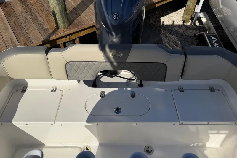Slide: The Image of 2026 Key West 203 FS boat interior with cushioned seating and storage compartments. - 14