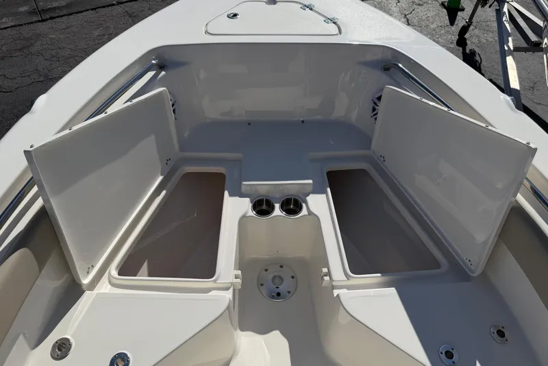 Slide: The Image of 2026 Key West 203 FS boat interior with open storage compartments and cup holders. - 19