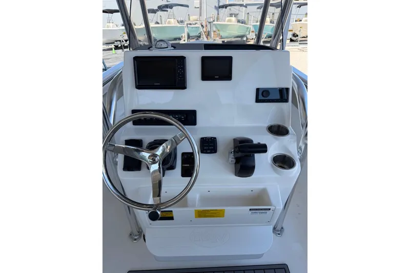 Slide: The Image of 2026 Key West 203 FS boat console with steering wheel, controls, and navigation screens. - 23