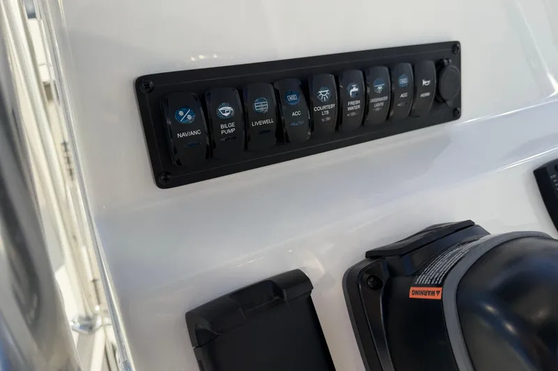 Slide: The Image of Control panel of 2026 Key West 203 FS boat with labeled switches. - 24