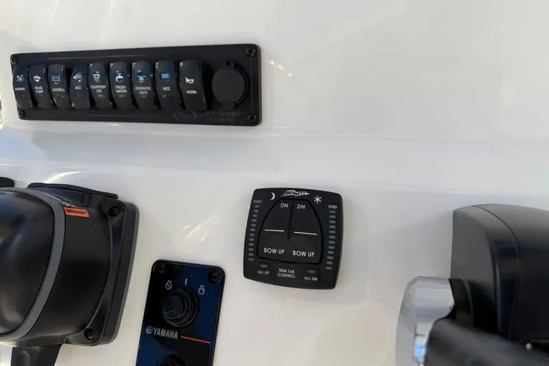 Slide: The Image of Control panel of 2026 Key West 203 FS boat with switches and trim tab controls. - 25