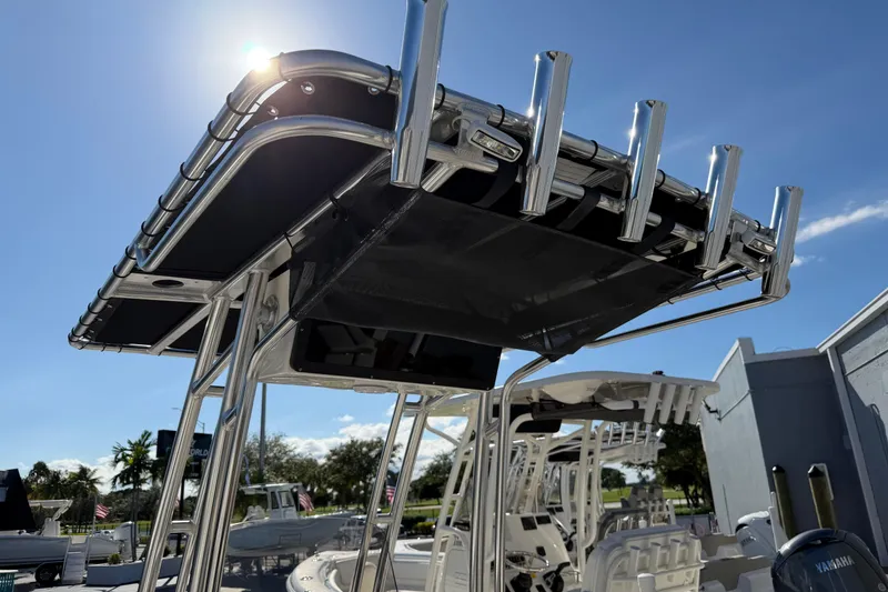 Slide: The Image of 2026 Key West 203 FS boat with T-top and rod holders under sunny sky. - 28