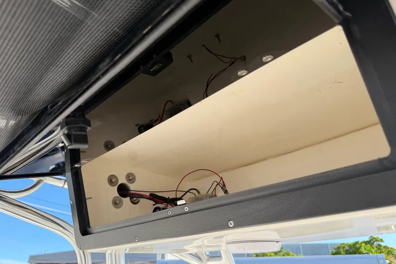 Slide: The Image of Open storage compartment on 2026 Key West 203 FS boat, showing wiring and interior details. - 29