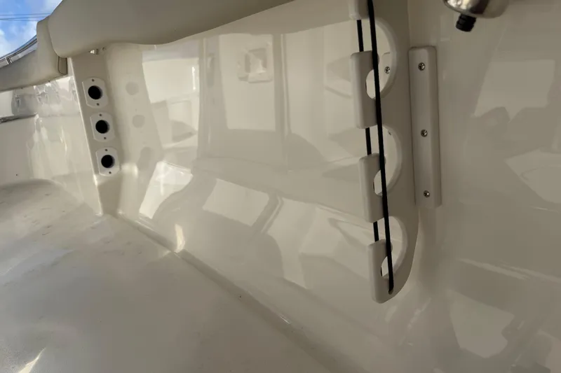 Slide: The Image of 2026 Key West 203 FS boat interior with rod holders and sleek white finish. - 33