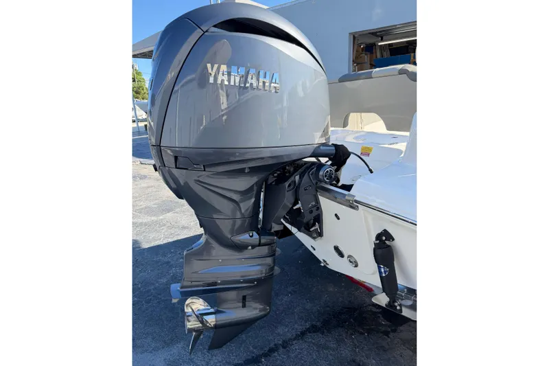 Slide: The Image of 2026 Key West 203 FS boat with Yamaha outboard motor, parked outdoors. - 8