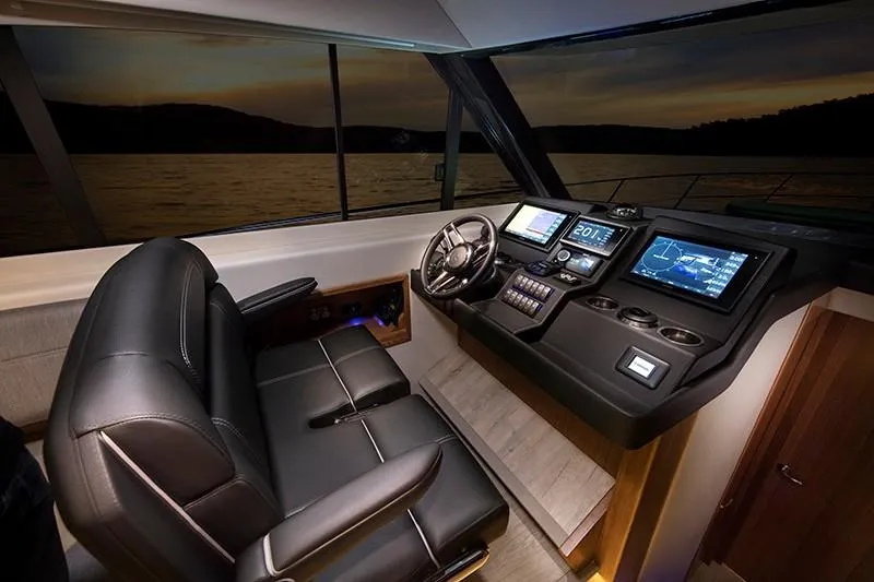 Slide: The Image of 2024 Riviera 395 SUV helm with advanced navigation systems and luxurious seating. - 12