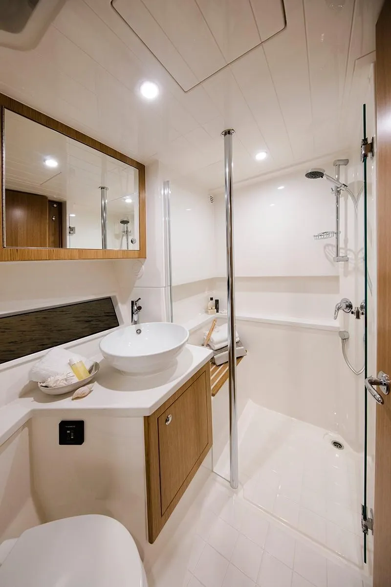 Slide: The Image of 2024 Riviera 395 SUV bathroom with modern fixtures and wooden cabinetry. - 15