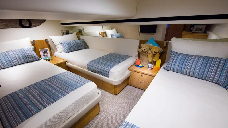 Slide: The Image of 2024 Riviera 395 SUV cabin with three beds and cozy decor. - 16