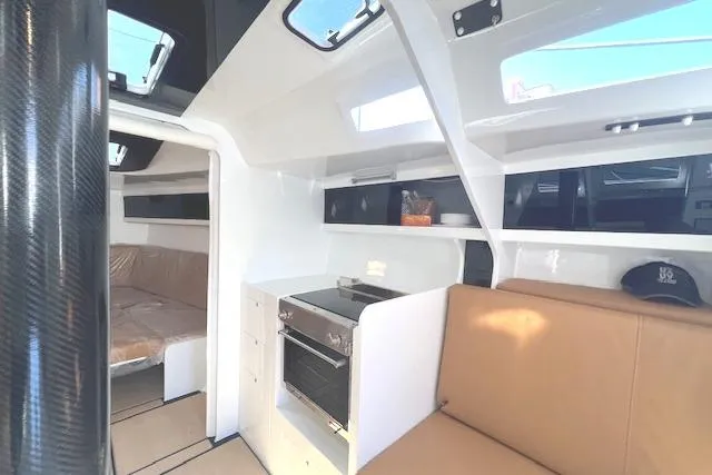 Slide: The Image of Interior of 2024 Neo 43 Romo yacht, featuring modern seating and kitchen area. - 7