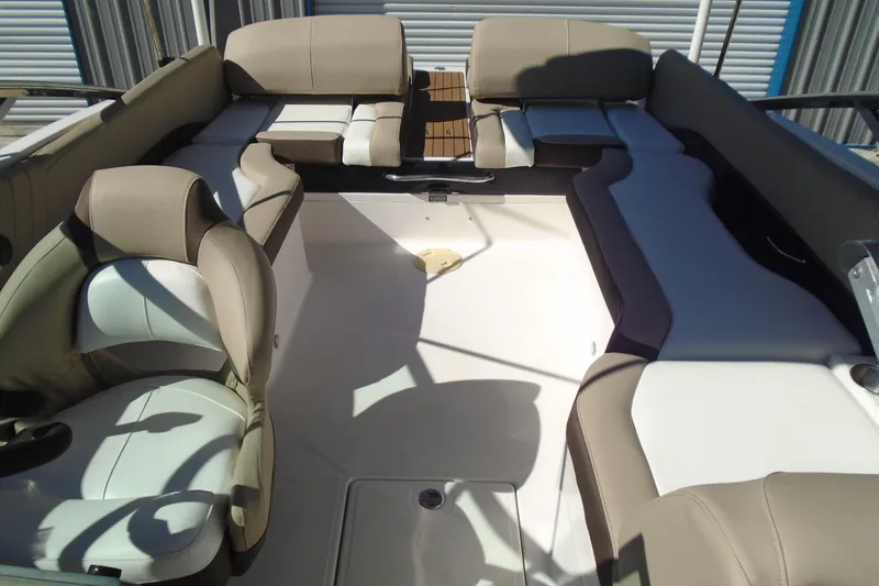 Slide: The Image of 2014 Regal 2300 Bowrider interior with beige seating and spacious layout. - 10