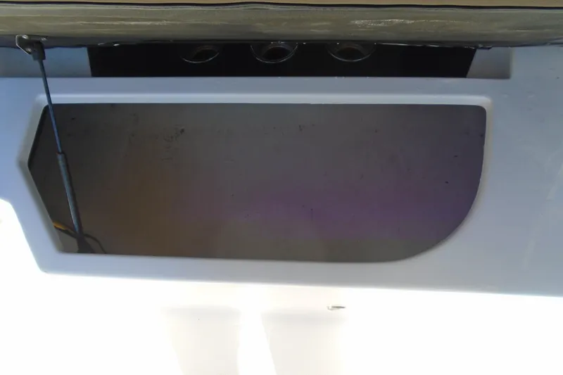 Slide: The Image of Storage compartment of a 2014 Regal 2300 Bowrider boat, open and empty. - 12