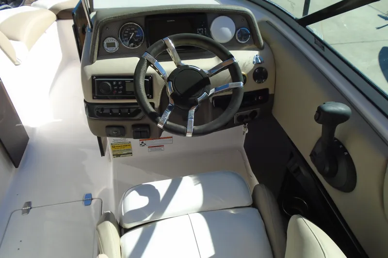 Slide: The Image of 2014 Regal 2300 Bowrider dashboard with steering wheel and controls. - 15