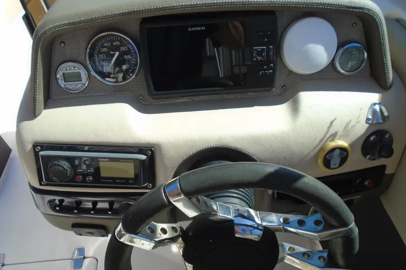Slide: The Image of Dashboard of a 2014 Regal 2300 Bowrider with steering wheel and navigation controls. - 16