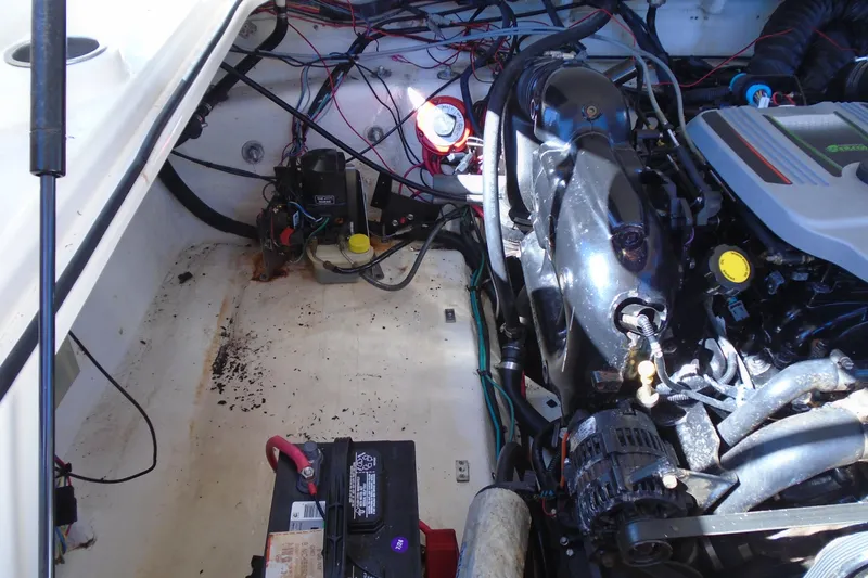 Slide: The Image of Engine compartment of a 2014 Regal 2300 Bowrider with visible wiring and battery. - 19