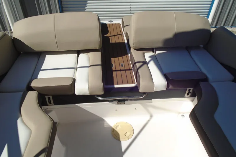 Slide: The Image of 2014 Regal 2300 Bowrider interior with beige and white seating, wooden accents. - 20
