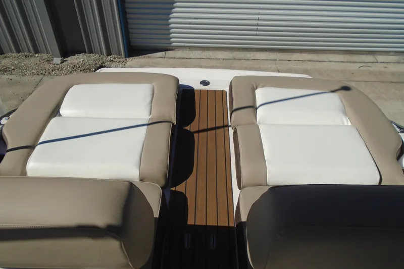 Slide: The Image of 2014 Regal 2300 Bowrider boat with beige and white cushioned seating. - 21