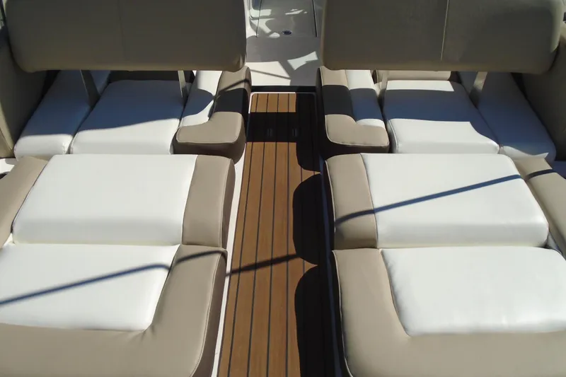 Slide: The Image of 2014 Regal 2300 Bowrider interior with beige and white cushioned seating. - 22