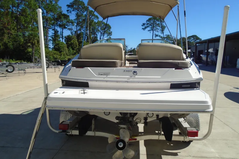Slide: The Image of 2014 Regal 2300 Bowrider boat on trailer, rear view, in outdoor setting. - 3
