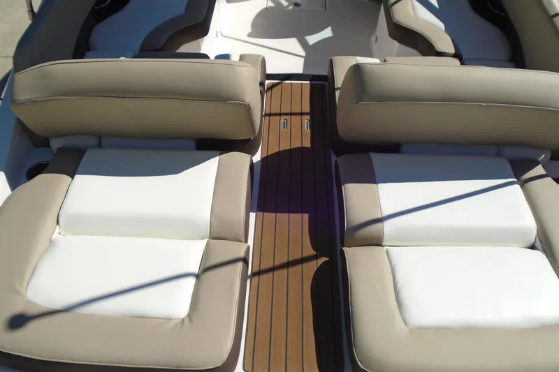 Slide: The Image of 2014 Regal 2300 Bowrider interior with beige and white seating, wooden flooring. - 7