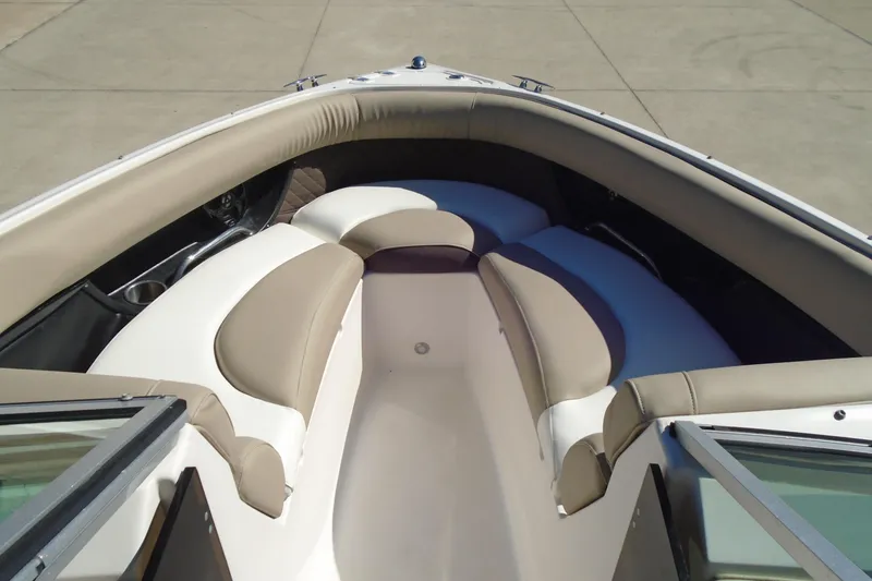Slide: The Image of 2014 Regal 2300 Bowrider boat interior with beige and white seating. - 9