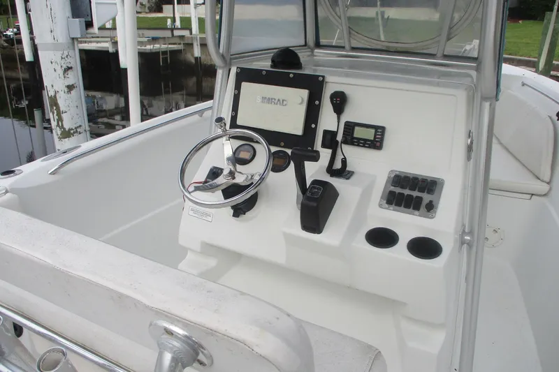 Slide: The Image of 2005 Sailfish 236 CC boat console with steering wheel and navigation controls. - 10