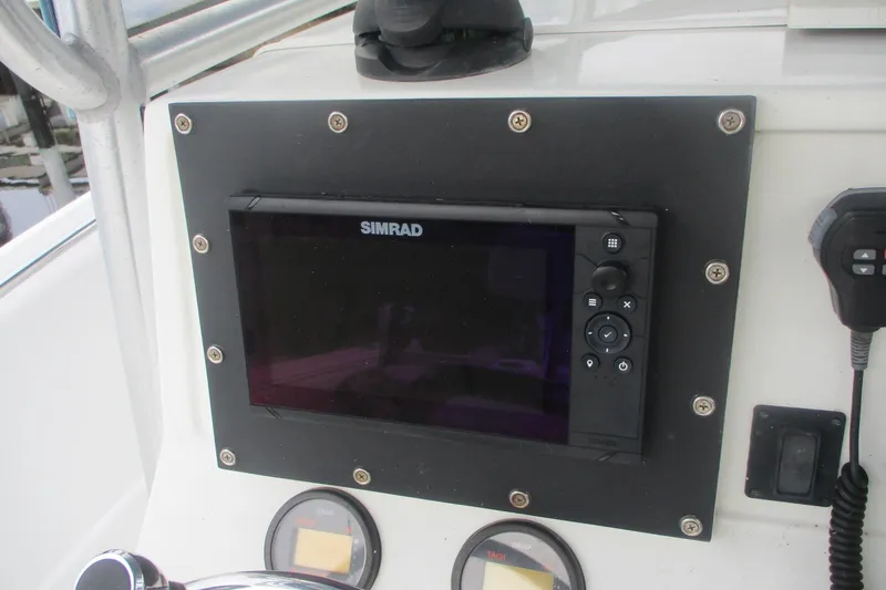 Slide: The Image of Simrad display on 2005 Sailfish 236 CC boat dashboard with controls and gauges. - 11